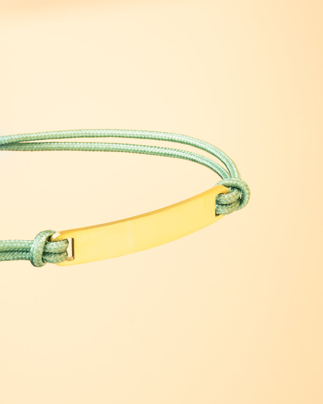 1.5mm green nylon bracelet with a stainless steel closing and gold-plated engraving plate